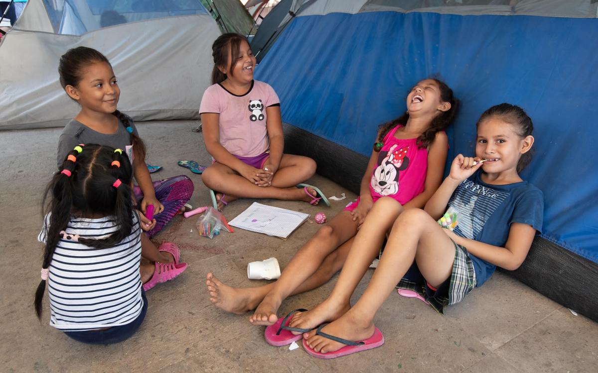 children playing in makeshift camp