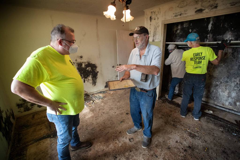 pastor visiting with LA resident after Ida