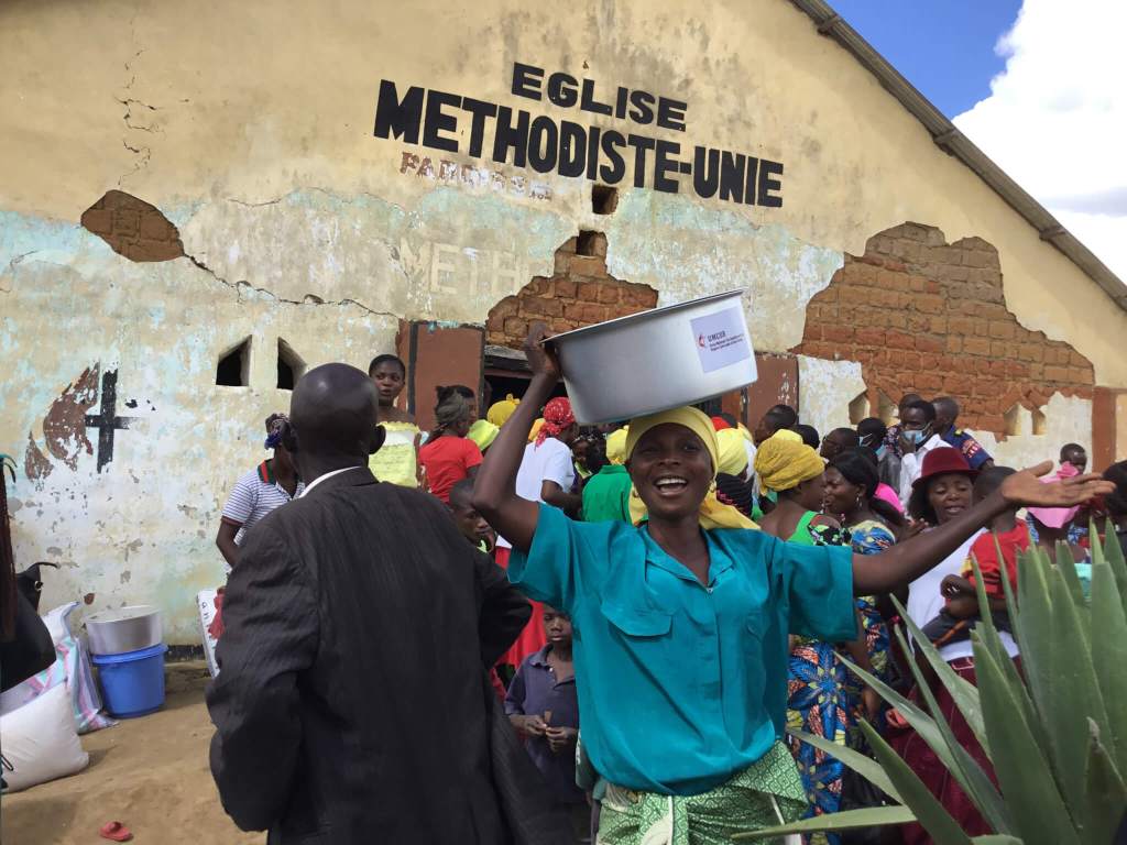 relief packages being distributed in a flooded area in DRC